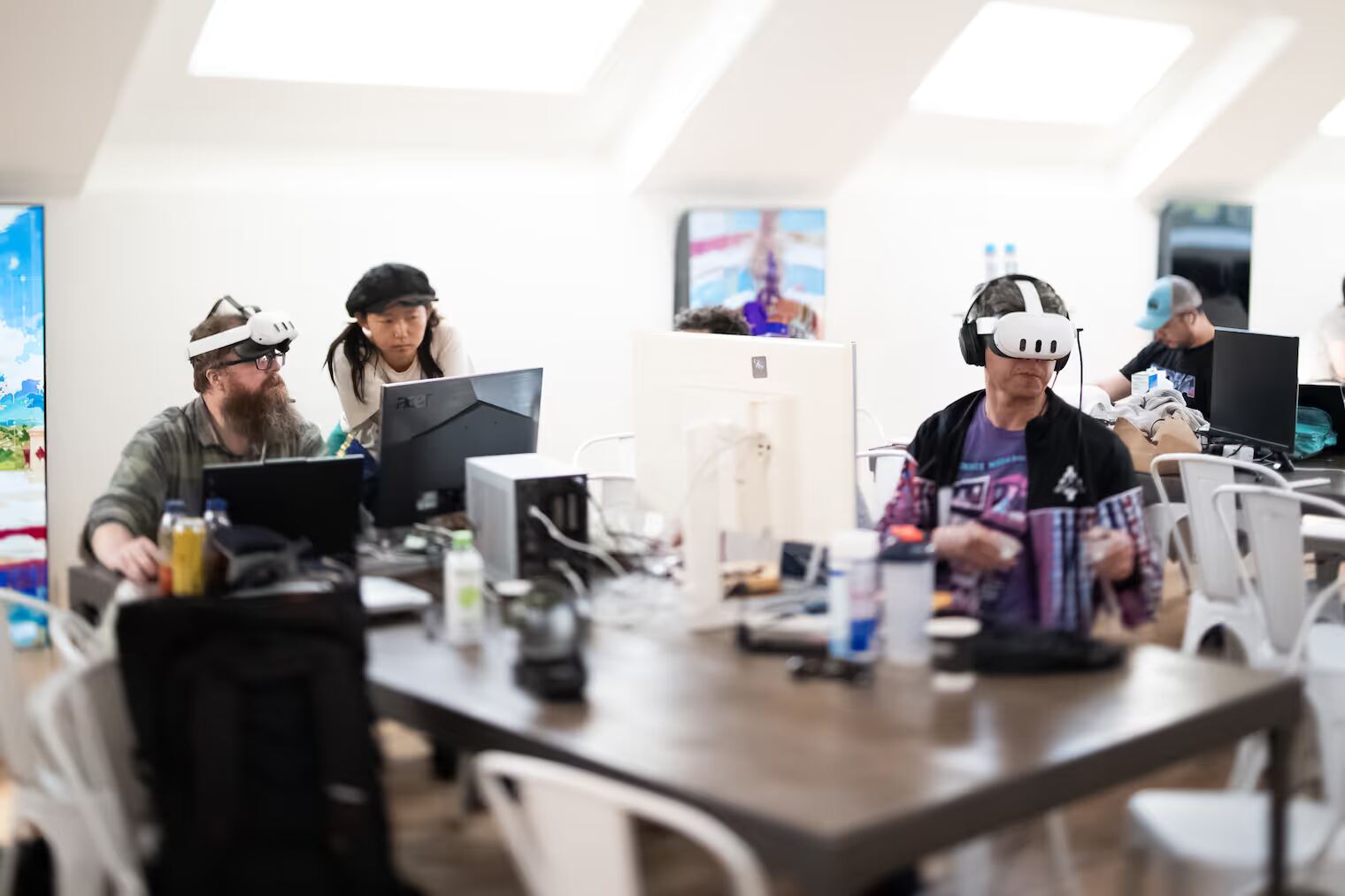 Residents building side by side in VR headsets at Edge City